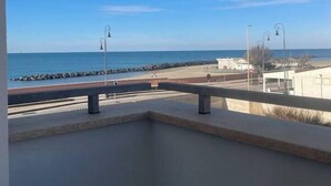 A balcony with a view of the sea and a beach. - House on the Beach, House on the beach near the airport (Isola Sacra)