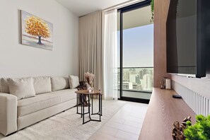 Signature Apartment | Living area | 50-inch Smart TV with digital channels