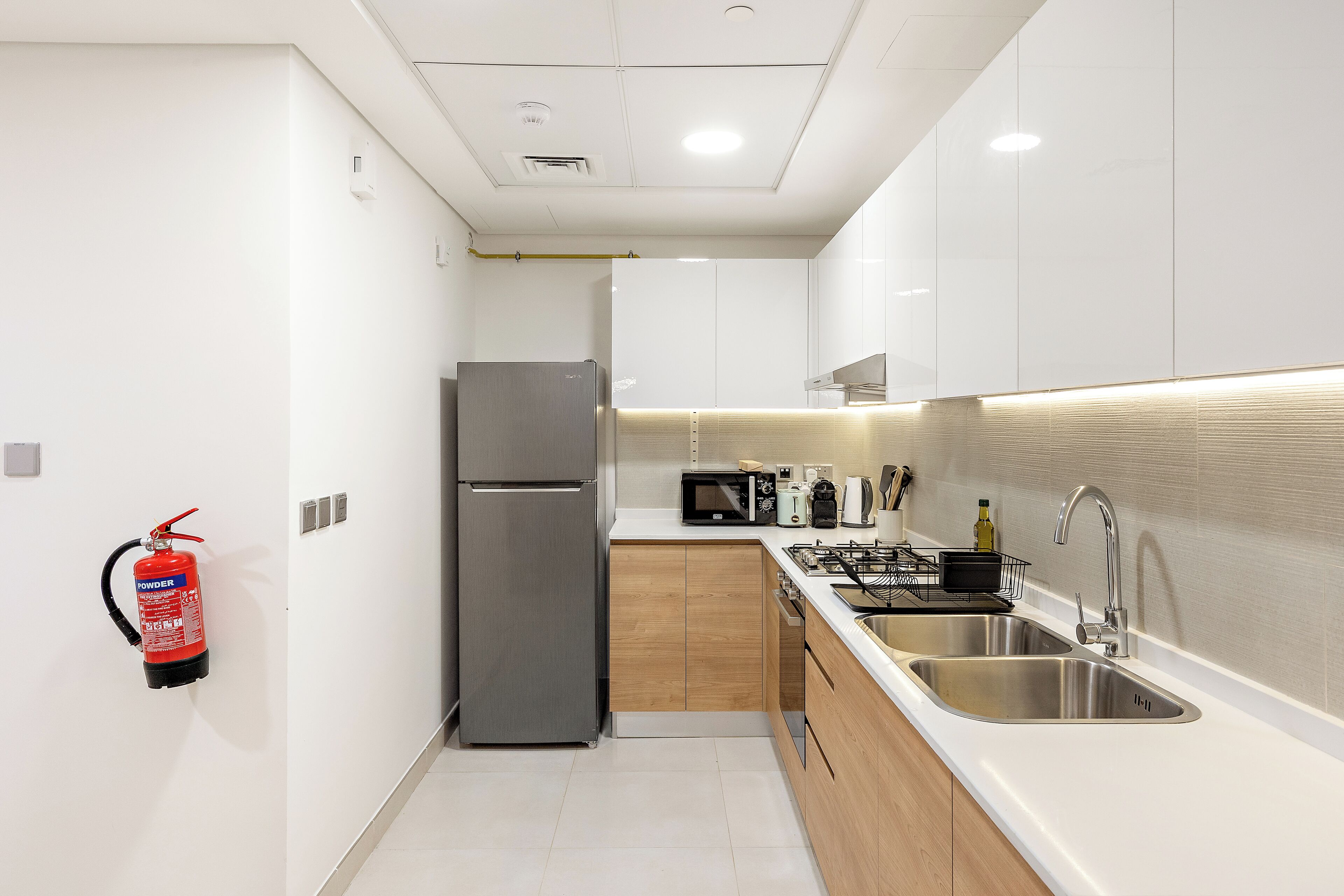 A modern kitchen with stainless steel appliances, a microwave, and a gas stove.