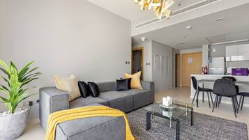 Standard Apartment | Living area | 50-inch Smart TV with digital channels