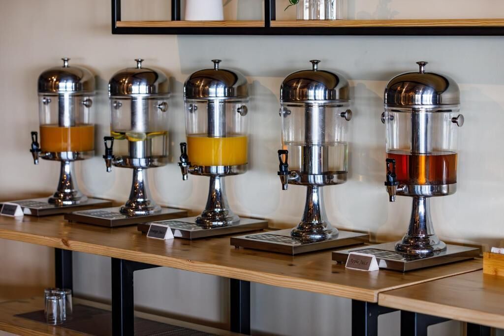 A row of coffee machines on a wooden counter.