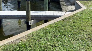A waterfront property with a small dock and a water channel.