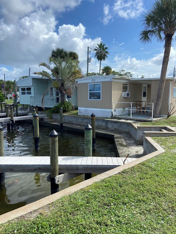 A waterfront property with a small dock and a water channel.