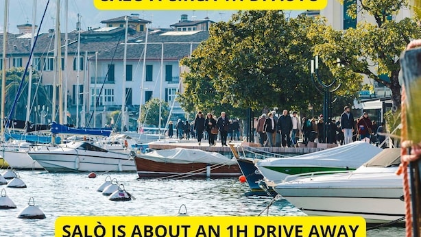 A marina with boats docked and people walking by. - Via Donati - O&R Home Crema (Crema)