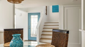 A dining area with wicker chairs, a glass table, and a blue vase. - Walk to the BEACH from this Monarch Bay Villa in Dana Point!! (Dana Point)