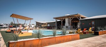 Cozy cabin with queen bed, full kitchen, and refreshing walk-in shower.