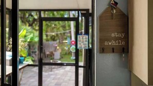 A doorway with a sign reading "stay awhile" and a sign indicating "outside." - Oasis privacy heated Pool Game room 3 mins Sister Spring (Crystal River)