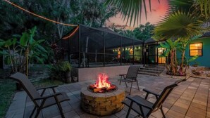 A patio area with a fire pit, outdoor seating, and a covered structure. - Oasis privacy heated Pool Game room 3 mins Sister Spring (Crystal River)