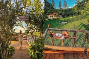 A wooden deck with a sign reading "Mirante da Lua dos Apaixonados" and a hammock with a person lying in it.
