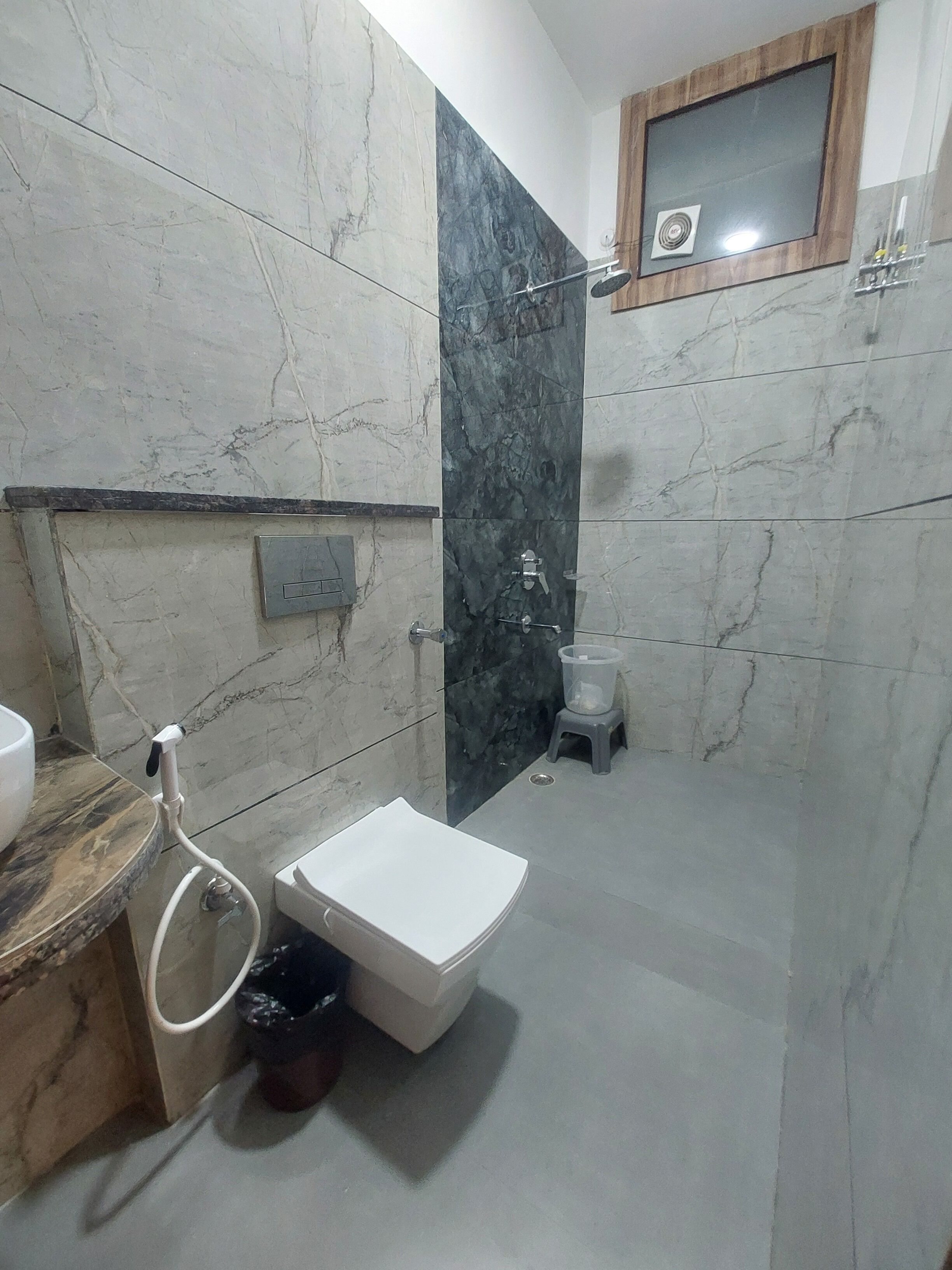 A bathroom with a white sink, a toilet, and a shower area.