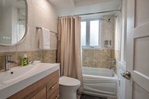 Een haardroger, handdoeken, zeep, toiletpapier