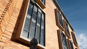 A modern building with large windows and a brick facade. - Spatium 134 (Bogotá)