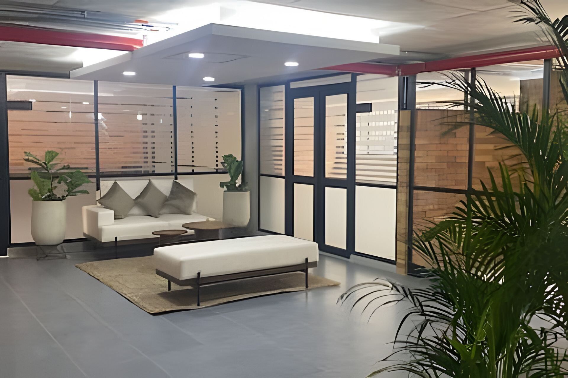 A modern interior with a sofa, a small table, and a bench.