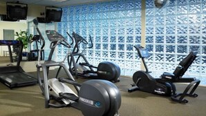A gym with treadmills, elliptical machines, and stationary bikes.