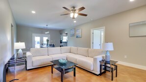 A spacious living room with a sectional sofa, a glass coffee table, and two side tables with lamps. - Quiet Hill Country Home: 1 Mi to Lake LBJ Access! (Granite Shoals)