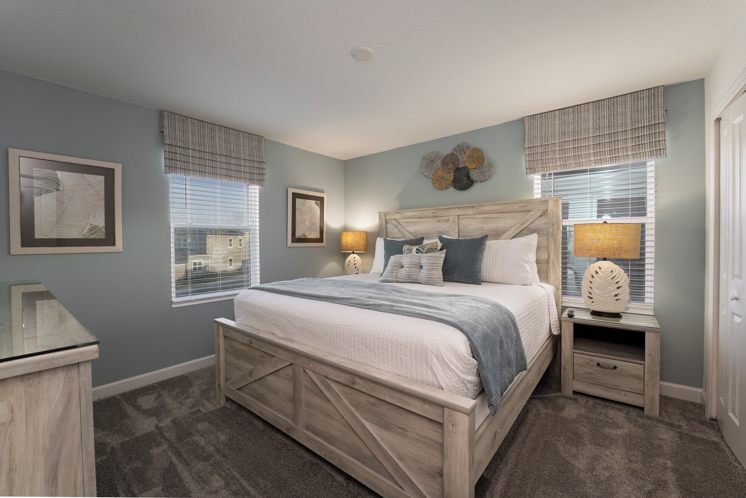 A bedroom with a wooden bed, bedside tables, and a nightstand.