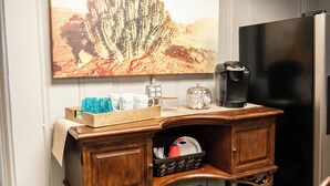 A wooden desk with a coffee maker, a basket, and a framed picture on the wall. - Beautiful sleeps 6 apartment, walking distance to Downtown Pilot Mountain Unit 1 (Pilot Mountain)