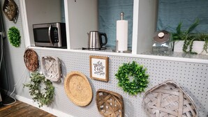 A kitchen with a microwave, kettle, and a framed picture on the wall. - Beautiful sleeps 6 apartment, walking distance to Downtown Pilot Mountain Unit 1 (Pilot Mountain)