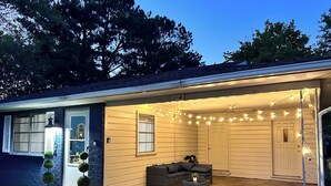 A house with a covered porch, a door, and a mailbox.