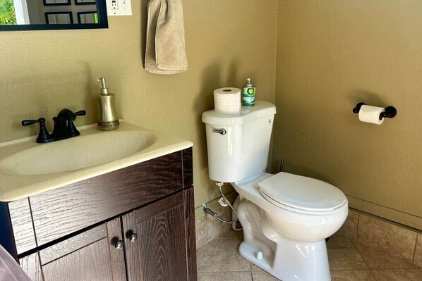A bathroom with a sink, toilet, and a towel hanging on the wall. - Spacious SoCal Retreat +Pool/Spa Backyard Paradise (Ontario)