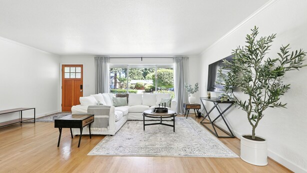 A modern living room with a white sofa, a coffee table, and a potted plant. - Quiet & Updated Vancouver Getaway • Family & Pet Friendly. AC & WIFI (Vancouver)