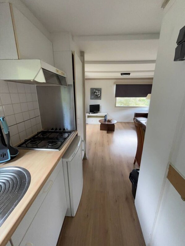 Fridge, coffee/tea maker, cookware/dishes/utensils, dining tables