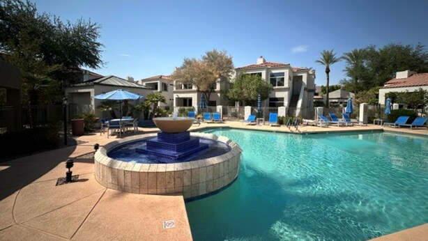 A swimming pool with a hot tub, lounge chairs, and a clear blue sky. - Luxurious Condo 2BD/2BA w/ Pool, Gym, and Sauna (Scottsdale)