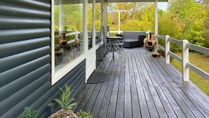 A covered deck with outdoor furniture, a pergola, and a view of the surrounding trees. - Amazing home in Glesborg with WiFi (Glesborg)