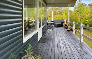 A covered deck with outdoor furniture, a pergola, and a view of the surrounding trees. - Amazing home in Glesborg with WiFi (Glesborg)