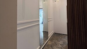 A hallway with a marble floor, a large mirror, and pendant lighting. - Charming 2-room Apartment in Heart of Rabat (Rabat)