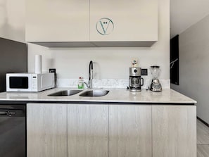 A kitchen with a microwave, coffee maker, and blender on the counter. - Tizate 3BR Private Beach Stunning View (La Cruz de Huanacaxtle)