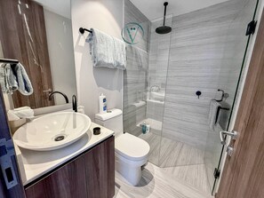 A modern bathroom with a large sink, toilet, and shower. - Tizate 3BR Private Beach Stunning View (La Cruz de Huanacaxtle)