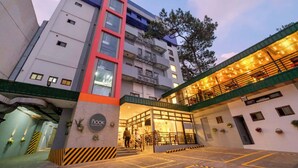 A multi-story hotel with a prominent red and white facade, a ground-level restaurant, and a staircase leading to the entrance. - Baguio LeFern Hotel (Baguio)
