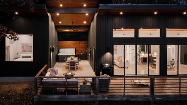 A modern house with a dining area, kitchen, and living spaces.