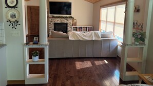 A cozy living room with a fireplace, a comfortable seating area, and a television. - Spacious Seneca Lake Retreat in the Heart of the Finger Lakes! (Burdett)