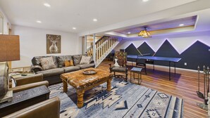 A spacious living area with a sofa, coffee table, and rug. - Beautiful log cabin high above the Rio Ruidoso River. The Log & Order Cabin. (Ruidoso)