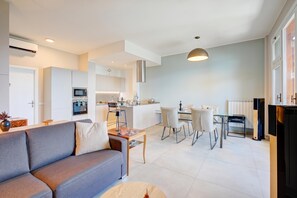 A modern apartment with a living room, kitchen, and dining area.