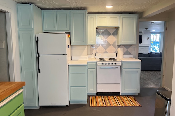 full kitchen with fridge, freezer, oven and stovetop.