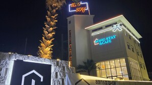 A building with a neon sign reading "SONG STAY" and "SONG STAY & CAFE". - song stay (Dangjin)