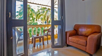 Studio with Balcony | Living area | 32-inch LED TV with satellite channels