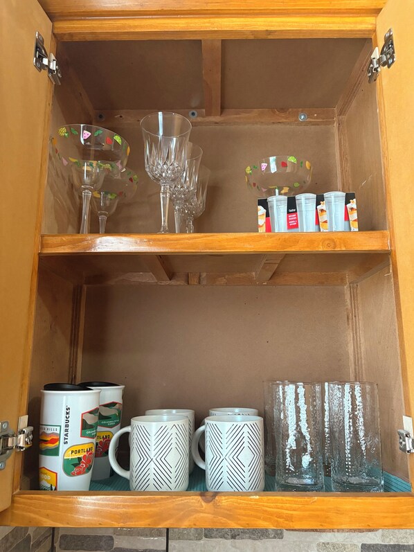 A wooden cabinet with shelves containing various items. - The Casita, you will feel right at home! (San Luis Río Colorado)