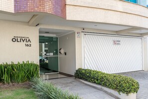 A residential building named 'OLIVIA 162' with a closed garage door and a security camera. - Apt W/balcony 160m Bombas Beach Col102 (Bombinhas)