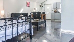 A modern hotel room with a bed, a desk, and a kitchenette. - 1 bedroom accommodation in Clitheroe (Clitheroe)