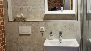 Shower, hair dryer, towels, toilet paper