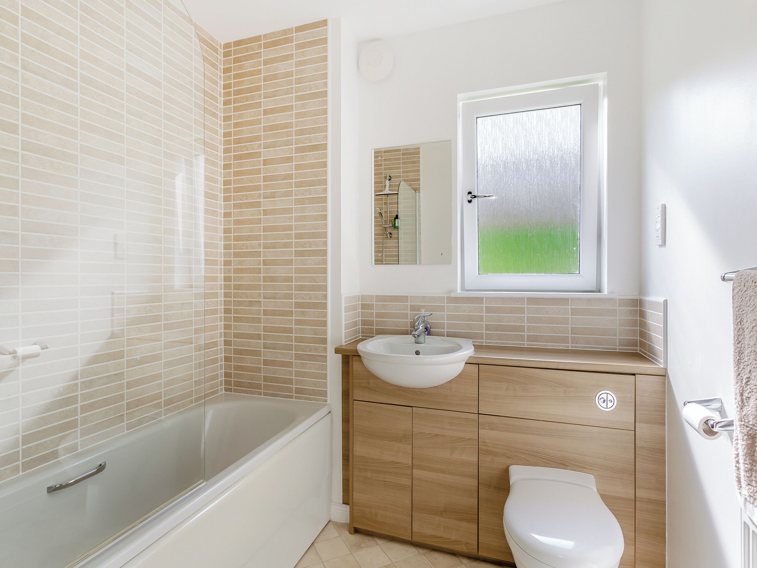 A bathroom with a bathtub, sink, and toilet.