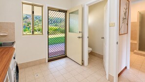 A bathroom with a toilet, a shower area, and a sink. - Chalwell Lodge – your luxurious rural retreat nestled in the heart of Carlotta. (Nannup)