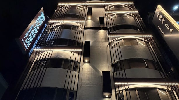 A hotel with a modern facade, illuminated signage, and a visible entrance. - Chang Hong Fashion Hotel - Taichung Wenxin Branch (Taichung)