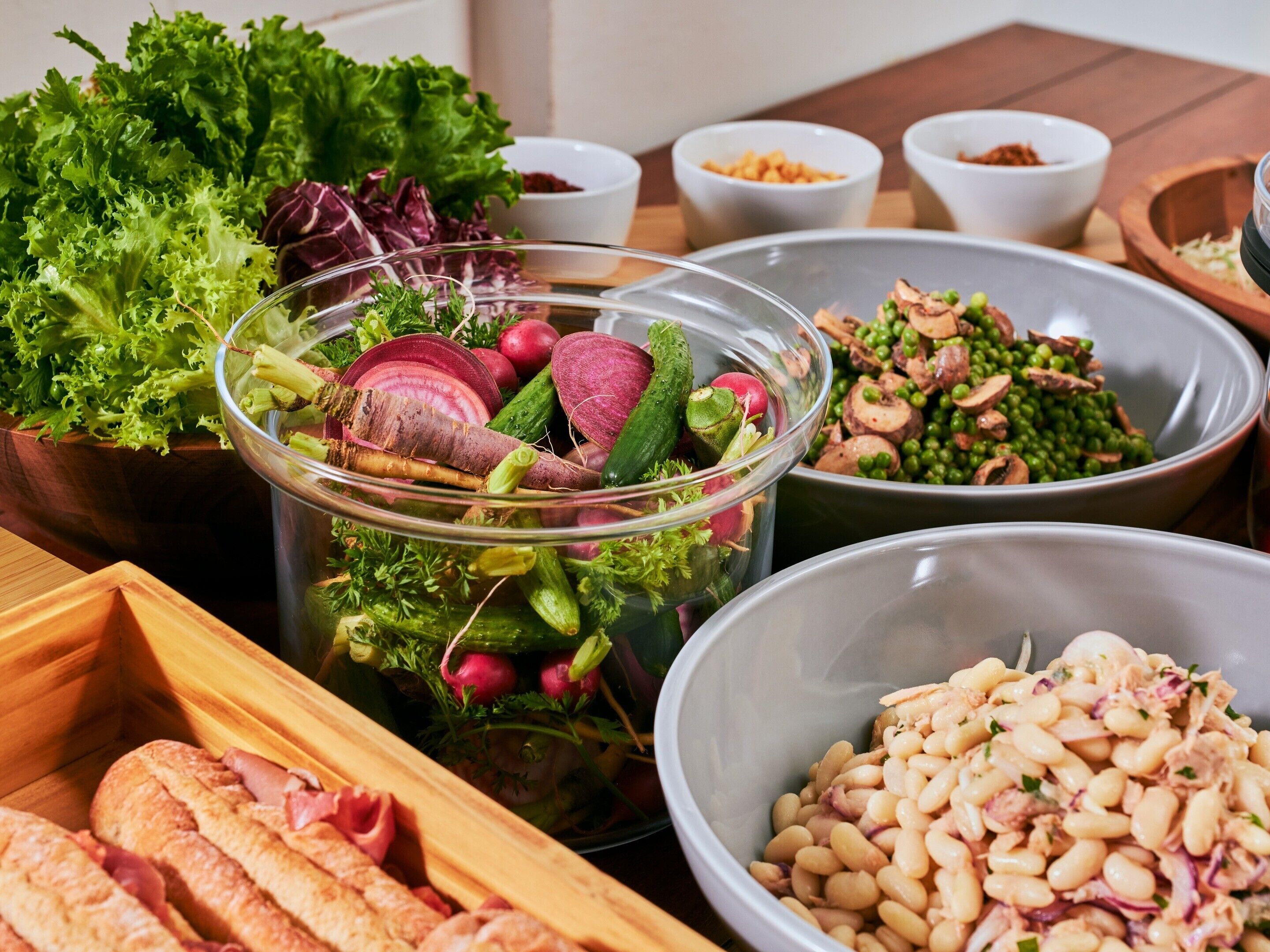 A variety of food items including a salad, beans, and vegetables.