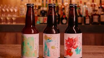 Three bottles with colorful labels on a bar counter.