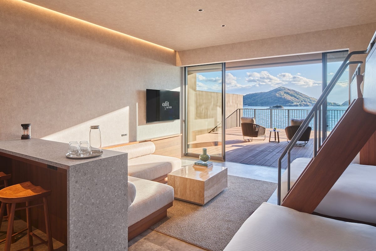A modern living room with a large window overlooking a scenic mountain view.